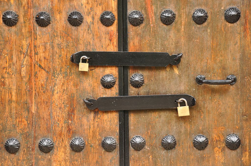 Double Locked Door to describe the opportunities and challenges of securing multipath network connections. Security of MPTCP vs TCP is the topic and MPTCP is represented here with a double locked door.